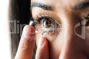 Woman about to insert her contact lens