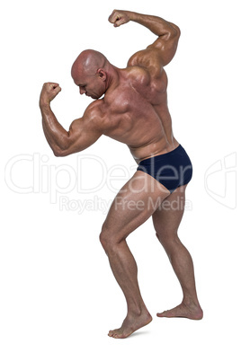 Powerful bald man flexing muscles
