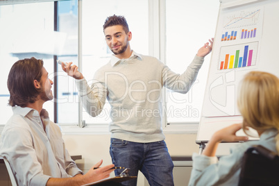 Confident businessman giving presentation in meeting room