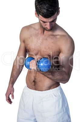 Shirtless man holding dumbbell