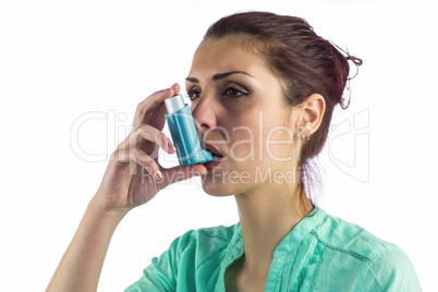 Close-up of woman using asthma inhaler