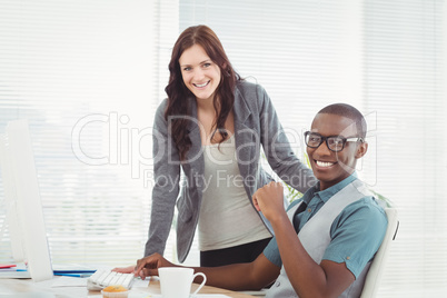 Portrait of smiling man wearing eyeglasses while working with co