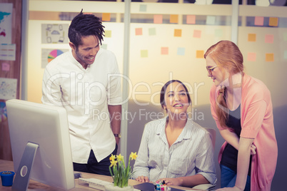 Smiling businesswomen with male colleague in office