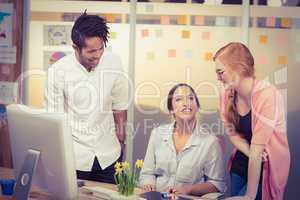 Smiling businesswomen with male colleague in office