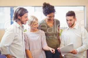 Business people smiling and looking at sheet of paper