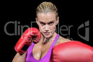 Portrait of female boxer with fighting stance