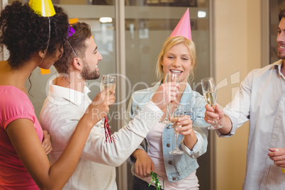 Colleagues toasting champagne in birthday party