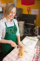 Female worker cutting sandwich
