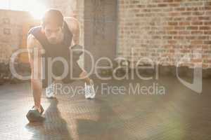 Focused man lifting dumbbell