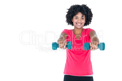 Portrait of happy young woman exercising with dumbbells