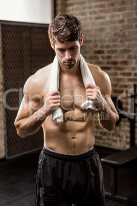 Muscular man holding towel