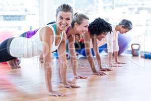 Happy women exercising on floor