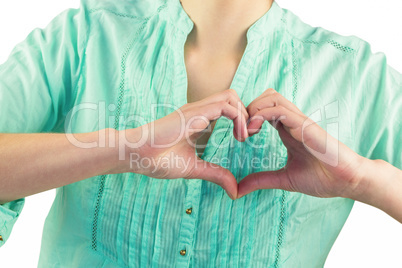 Mid section of woman making heart shape of fingers