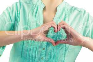 Mid section of woman making heart shape of fingers
