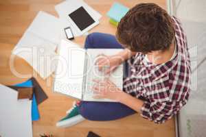 Creative businessman working on laptop in office