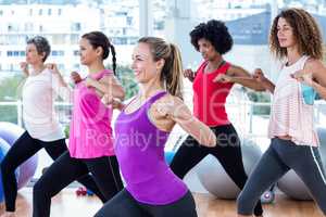 Women exercising with clasped hands and stretching