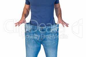 Midsection of man stretching denim jeans