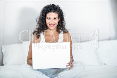 Portrait of beautiful pregnant woman using laptop