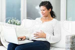 Happy woman using laptop