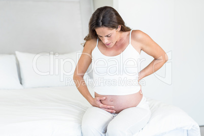 Unhappy pregnant woman suffering from back pain