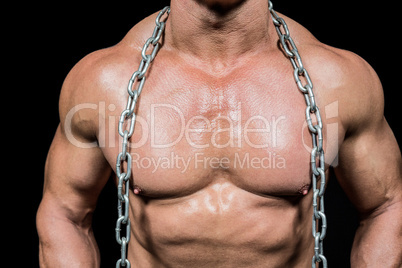 Midsection of muscular man with chain Midsection of muscular man with chain