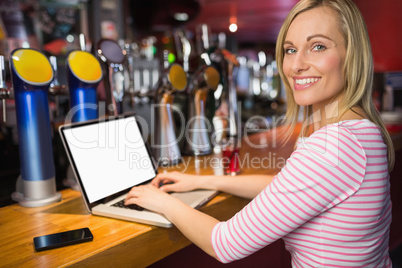 Portrait of happy woman using laptop