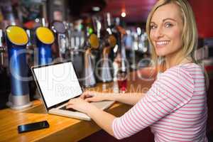 Portrait of happy woman using laptop