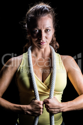 Portrait of woman holding rope around neck