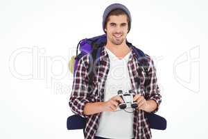 Happy hipster wearing backpack holding binoculars