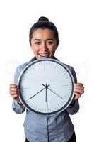 Happy woman showing her large clock
