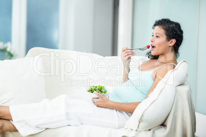 Happy woman eating salad