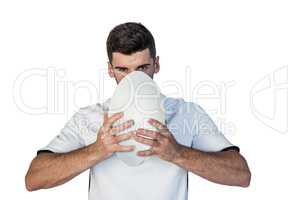 Portrait of serious rugby player holding the ball