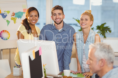 Portrait of smiling business people using computer