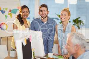 Portrait of smiling business people using computer