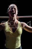 Angry woman screaming while holding rope