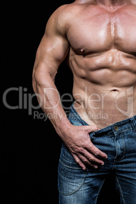 Midsection of sexy man pulling denim