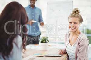 Portrait of smiling woman with coworker