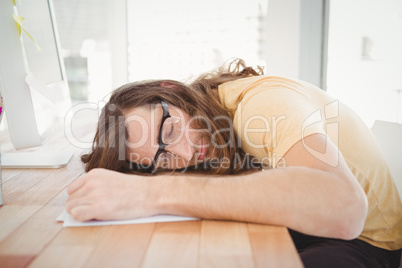 Tired hipster resting at computer desk