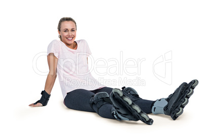 Portrait of happy female inline skater relaxing