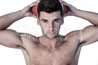 Portrait of a man holding ball over his head Portrait of a man holding ball over his head