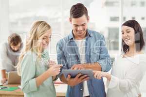 Happy Business professionals using digital tablet