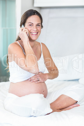 Portrait of cheerful woman listening to smartphone