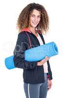 Portrait of happy young woman holding exercise mat