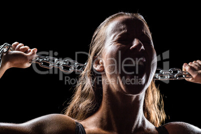 Angry female athlete holding chain