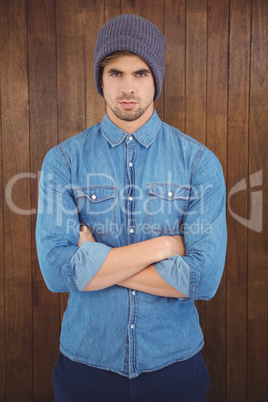 Portrait of serious hipster with arms crossed