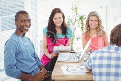 Portrait of happy business people sitting on chair Portrait of happy business people sitting on chair