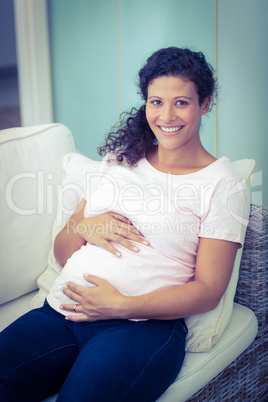 Portrait of happy woman on lounge furniture