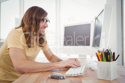Happy hipster working on computer