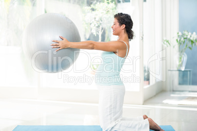 Pregnant woman holding exercise ball