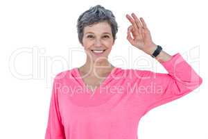 Happy mature woman showing OK sign